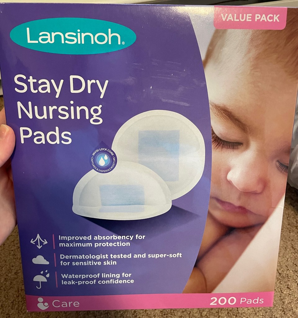package of Lansinoh Stay Dry Nursing Pads. The packaging highlights that the product has improved absorbency, is dermatologist tested for sensitive skin, and contains a waterproof lining for leak-proof confidence. It mentions a value pack of 200 pads.